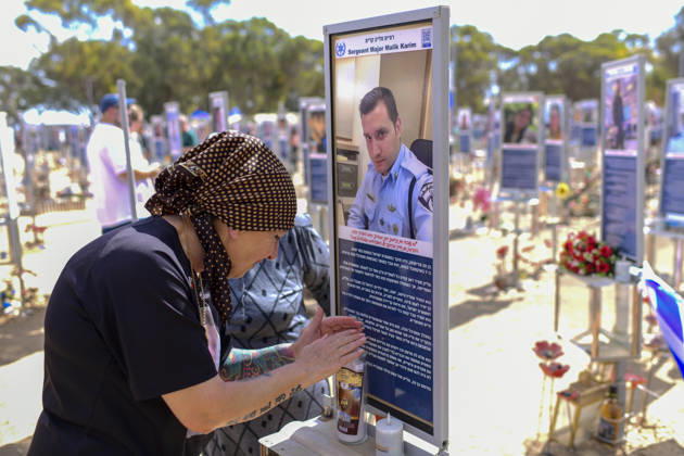 Reim Nova Memorial Marks Anniversary A woman wearing a headscarf presses her hands against a memorial portrait plaque at the Nova music festival memorial site near Reim, southern Israel, on October 7, 2026. The Hamas-led attack on Israel on October 7, 2023, killed about 1,200 people and saw 251 taken hostage; more than 350 people were killed at the Nova festival. Memorial events marking the third anniversary were held at the site throughout the day. Reim Southern District Israel Copyright: xTomerxNeubergx