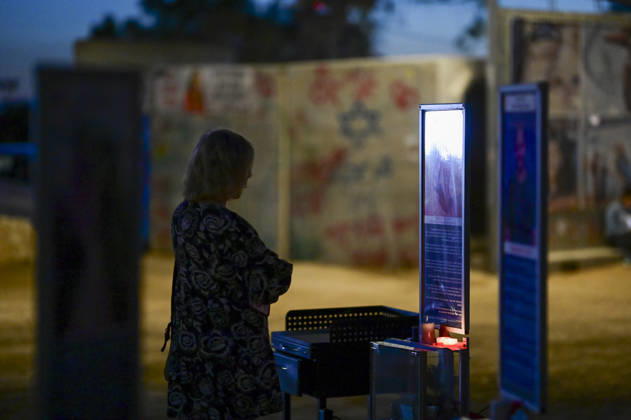 Reim Nova Memorial Marks Anniversary A silhouetted visitor stands beside an illuminated memorial panel after dark at the Nova music festival memorial site near Reim, southern Israel, on October 7, 2026. The Hamas-led attack on Israel on October 7, 2023, killed about 1,200 people and saw 251 taken hostage; more than 350 people were killed at the Nova festival. Memorial events marking the third anniversary were held at the site throughout the day. Reim Southern District Israel Copyright: xTomerxNeubergx
