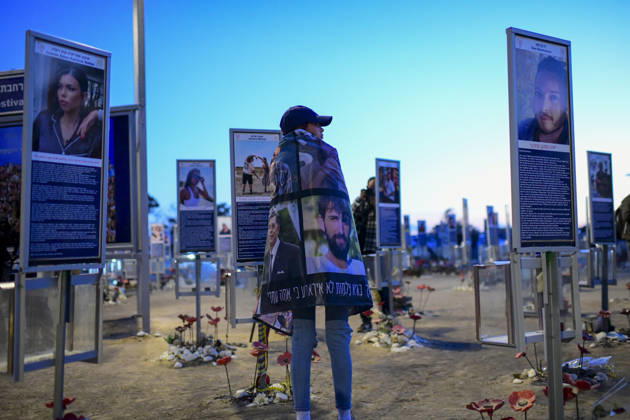 Reim Nova Memorial Marks Anniversary A woman wrapped in a memorial blanket stands among portrait plaques and flowers at the Nova music festival memorial site near Reim, southern Israel, on October 7, 2026. The Hamas-led attack on Israel on October 7, 2023, killed about 1,200 people and saw 251 taken hostage; more than 350 people were killed at the Nova festival. Memorial events marking the third anniversary were held at the site throughout the day. Reim Southern District Israel Copyright: xTomerxNeubergx