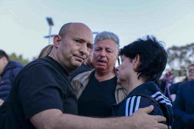 Reim Nova Memorial Marks Anniversary Former Israeli prime minister Naftali Bennett places a hand on a woman s shoulder as another mourner stands behind them at the Nova music festival memorial site near Reim, southern Israel, on October 7, 2026. The Hamas-led attack on Israel on October 7, 2023, killed about 1,200 people and saw 251 taken hostage; more than 350 people were killed at the Nova festival. Memorial events marking the third anniversary were held at the site throughout the day. Reim Southern District Israel Copyright: xTomerxNeubergx