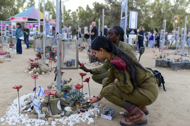 Reim Nova Memorial Marks Anniversary Two women in olive-colored clothing tend flowers and candles at a memorial at the Nova music festival memorial site near Reim, southern Israel, on October 7, 2026. The Hamas-led attack on Israel on October 7, 2023, killed about 1,200 people and saw 251 taken hostage; more than 350 people were killed at the Nova festival. Memorial events marking the third anniversary were held at the site throughout the day. Reim Southern District Israel Copyright: xTomerxNeubergx
