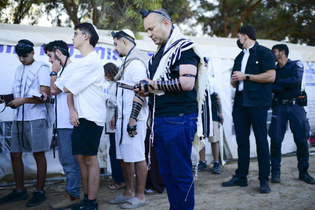 Reim Nova Memorial Marks Anniversary Jewish worshippers wearing tallit and tefillin stand in a line during prayers at the Nova music festival memorial site near Reim, southern Israel, on October 7, 2026. The Hamas-led attack on Israel on October 7, 2023, killed about 1,200 people and saw 251 taken hostage; more than 350 people were killed at the Nova festival. Memorial events marking the third anniversary were held at the site throughout the day. Reim Southern District Israel Copyright: xTomerxNeubergx
