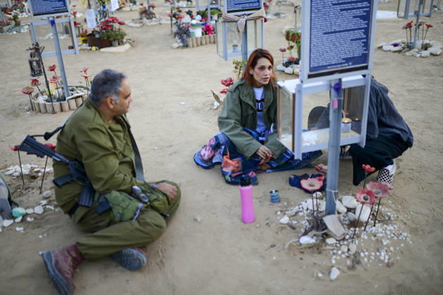 Reim Nova Memorial Marks Anniversary A man in an Israeli military uniform kneels while speaking with a seated woman beside a memorial at the Nova music festival memorial site near Reim, southern Israel, on October 7, 2026. The Hamas-led attack on Israel on October 7, 2023, killed about 1,200 people and saw 251 taken hostage; more than 350 people were killed at the Nova festival. Memorial events marking the third anniversary were held at the site throughout the day. Reim Southern District Israel Copyright: xTomerxNeubergx