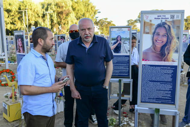 Reim Nova Memorial Marks Anniversary A man in a navy shirt stands with another visitor between memorial portrait plaques at the Nova music festival memorial site near Reim, southern Israel, on October 7, 2026. The Hamas-led attack on Israel on October 7, 2023, killed about 1,200 people and saw 251 taken hostage; more than 350 people were killed at the Nova festival. Memorial events marking the third anniversary were held at the site throughout the day. Reim Southern District Israel Copyright: xTomerxNeubergx