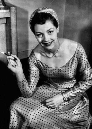 Actress is Her Own Dressmaker. Glamorous to her skilled finger tips is film star Diane Hart, who has the distinction of being an actress capable of making her own clothes. She is pictured at her London home in one of her own creations - a