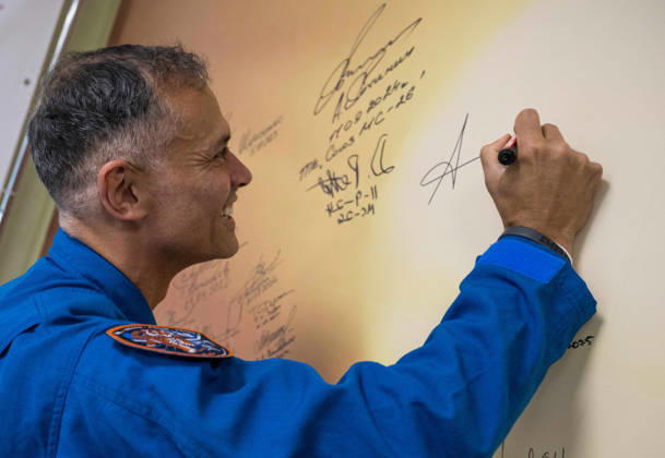 October 8, 2026, Baikonur, Kazakhstan: Baikonur, Kazakhstan. 14 July, 2026. NASA astronaut Anil Menon signs a mural at the Cosmonaut Hotel before departing for suit-up and launch, July 14, 2026 in Baikonur, Kazakhstan. Signing the mural is a preflight tradition. Baikonur Kazakhstan - ZUMAp138 20261008_zaa_p138_027 Copyright: xBillxIngalls Nasax