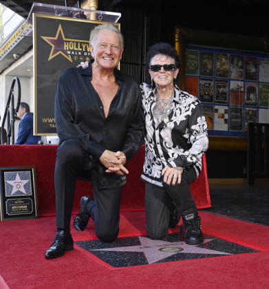 Graham Russell (L) and Russell Hitchcock of the rock duo Air Supply kneel next to their star during an unveiling ceremony honoring them with the 2,859th star on the Hollywood Walk of Fame in Los Angeles on Thursday October 8, 2026.  LAP2026100809 JIMxRUYMEN