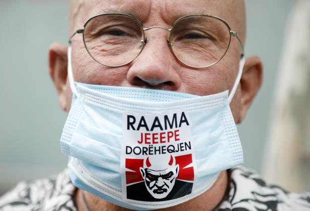 Demonstration Against the Proposed Territorial Reform in Tirana, Albania. A man wears a protective mask reading Rama, give your resignation during an anti-government protest against the government s administrative and territorial reform, in front of the Parliament building in Tirana, Albania, on October 8, 2026. Light Studio Agency Malton Dibra Tirana Albania Copyright: xLightxStudioxAgencyx xMaltonxDibrax