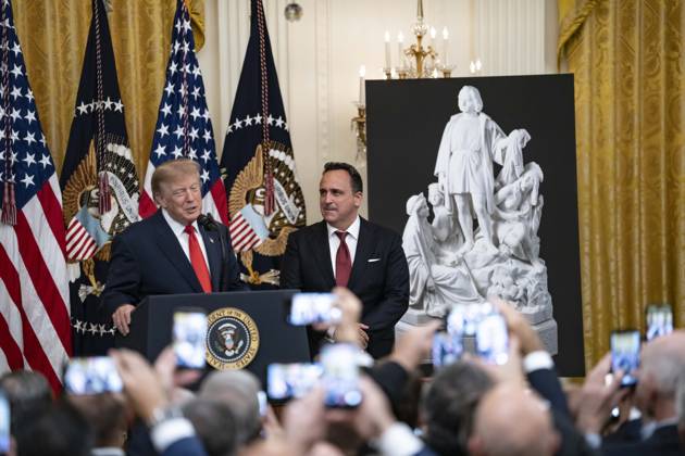United States President Donald J Trump makes remarks as singer Christopher Macchio looks on during a Columbus Day Celebration in the East Room of the White House in Washington, DC, USA on Friday, October 8, 2026. Copyright: xAaronxSchwartz PoolxviaxCNPx MediaPunchx