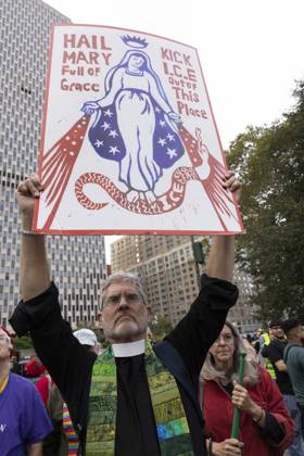 October 9, 2026, New York, New York, USA: A demonstrator holds a sign that reads HAIL MARY Full of Grace KICK I.C.E. Out of This Place. Thousands of people join the Hands Off NYC coalition at a rally outside Federal Plaza in Lower Manhattan before marching through the streets for an emergency protest demanding justice the day following ICE shooting a Bronx man while his 5 year child was in the car. New York USA  - ZUMAr174 20261009_znp_r174_020 Copyright: xGinaxMxRandazzox