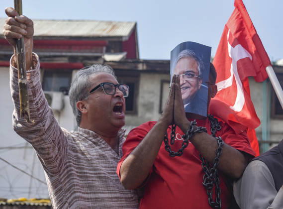 October 10, 2026, Srinagar, Jammu And Kashmir, India: An INDIA bloc supporter wearing a mask depicting Chief Election Commissioner Gyanesh Kumar and holding a chain during a protest demanding the resignation of India s Chief Election Commissioner Gyanesh Kumar over alleged voter roll irregularities linked to the special intensive revision (SIR), in Srinagar on October 10, 2026. Srinagar India  - ZUMAz120 20261010_zip_z120_006 Copyright: xBasitxZargarx