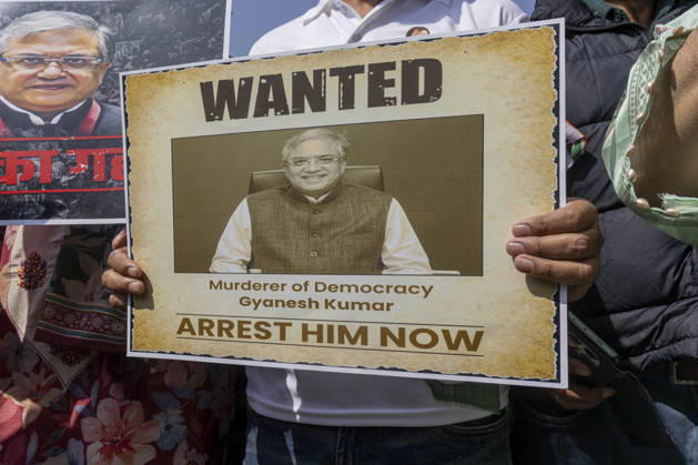 October 10, 2026, Srinagar, Jammu And Kashmir, India: A man holds a plea card at Congress Bhawan as INDIA bloc alliance partners stage a protest under the Save Democracy Week and Vote Bachao, Desh Bachao campaign, amid row over the resignation of Chief Election Commissioner Gyanesh Kumar in Srinagar, the capital city of Indian Kashmir. Srinagar India  - ZUMAf191 20261010_zip_f191_003 Copyright: xUmarxFarooqx
