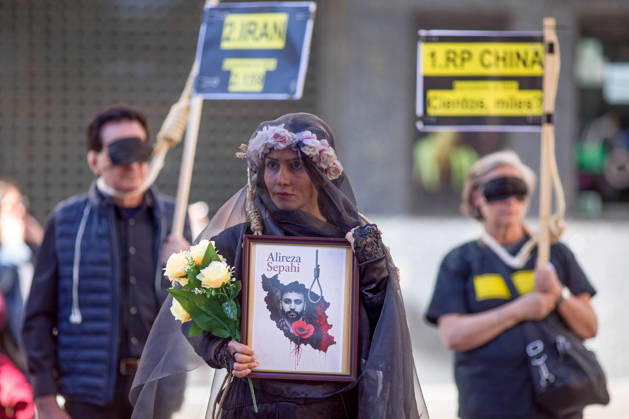 October 10, 2026, Madrid, Spain: A woman holds a portrait with a veil on her head, during a rally against the death penalty in Callao Square in central Madrid. World Day Against the Death Penalty has been observed every October 10th since 2003. Madrid Spain - ZUMAs197 20261010_aaa_s197_024 Copyright: xLuisxSotox