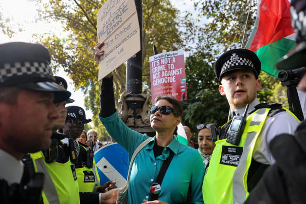 October 10, 2026, London, London, UK: London, UK. A pro-Palestine supporter is detained by the police for holding a sign as thousands of take part in the National March for Palestine in central London, carrying placards and Palestinian flags and calling for Palestinian rights and an end to the conflict in Gaza, three days after the third anniversary of the 7 October attacks on Israel. London UK  - ZUMAl94_ 20261010_zaf_l94_036 Copyright: xDinendraxHariax