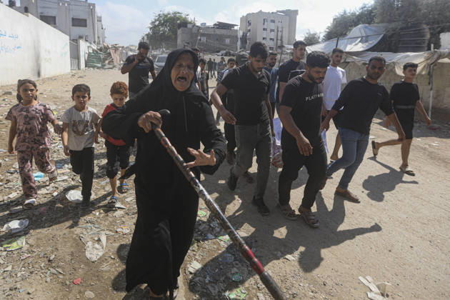 Gaza Palestine Airstrike Aftermath An elderly woman walks ahead of mourners carrying a shrouded body in Gaza City, Palestine on October 10, 2026. Four Palestinians were killed in an air strike near Panda Mall, and people carried the victims toward Al-Shifa Hospital for funeral prayers. Gaza Gaza Strip Palestinian Territories Copyright: xIbrahimxZanounx