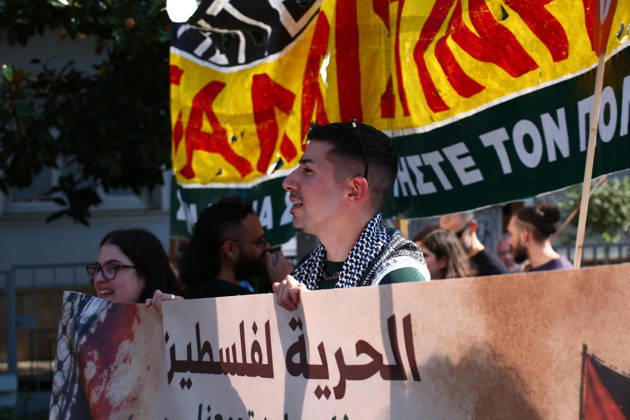 October 10, 2026, Athens, Attica, GREECE: A demonstrator wearing a Palestinian keffiyeh marches behind a banner calling for freedom for Palestine. Athens GREECE  - ZUMAx103 20261010_zip_x103_015 Copyright: xHarrisxXanthopoulosx