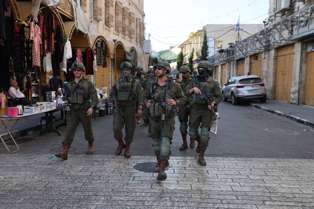 Israeli settlers enter Hebron Old City under military protection HEBRON, OCCUPIED WEST BANK, OCTOBER 10, 2026: Israeli settlers enter Hebron s Old City under the protection of Israeli forces during an organized visit to the area. Israeli soldiers deployed along streets and around the group as settlers moved through the Old City, where Israeli settlers and Palestinian residents live in close proximity amid longstanding tensions and movement restrictions. HEBRON Palestine, State of Copyright: x xMosabxshawerx xJNAxPressx