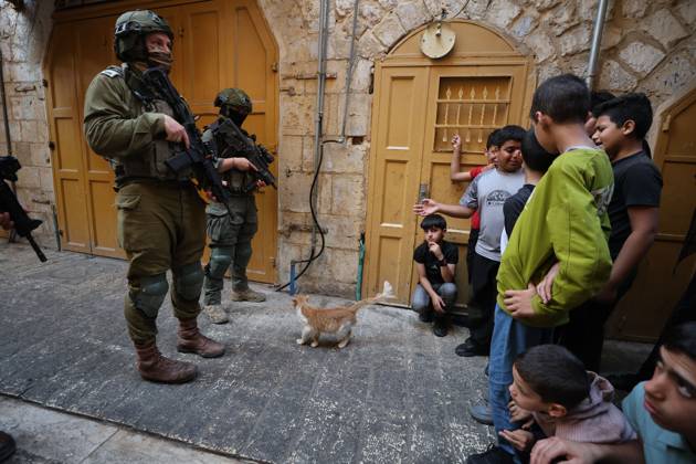 Israeli settlers enter Hebron Old City under military protection HEBRON, OCCUPIED WEST BANK, OCTOBER 10, 2026: Israeli settlers enter Hebron s Old City under the protection of Israeli forces during an organized visit to the area. Israeli soldiers deployed along streets and around the group as settlers moved through the Old City, where Israeli settlers and Palestinian residents live in close proximity amid longstanding tensions and movement restrictions. HEBRON Palestine, State of Copyright: x xMosabxshawerx xJNAxPressx