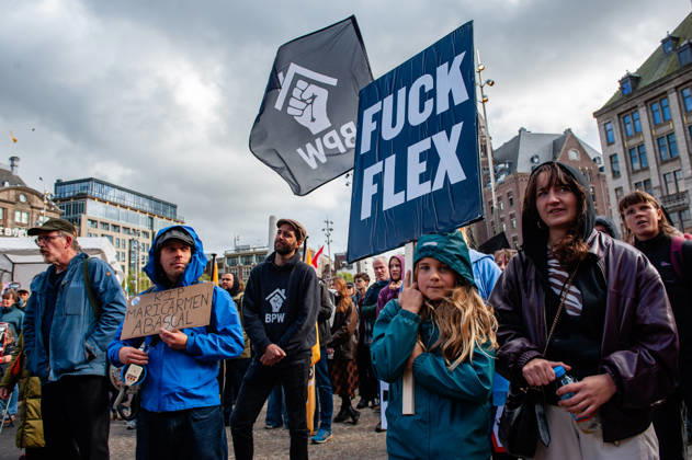 October 10, 2026, Amsterdam, North Holland, Netherlands: (EDITOR S NOTE: Image depicts profanity) .Protesters listen to the speeches while holding placards during the demonstration. People gathered against the worsening housing crisis. Under the motto Houses for people, not for profit, they demand fundamental changes in Dutch public housing. Amsterdam Netherlands  - ZUMAs197 20261010_aaa_s197_557 Copyright: xAnaxFernandezx