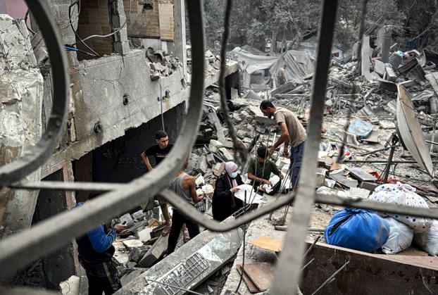 Palestinians Inspect Damage After Strike in Deir al-Balah Palestinians inspect their belongings amid the rubble of damaged residential buildings and their displacement tents after an Israeli airstrike targeted a house in Deir al-Balah, in the central Gaza Strip, on October 11, 2026. Photo by Ahmed Ibrahim apaimages Deir al-Balah Gaza Palestinian Territory 111026_Deir_al-Balah_AI_00(14) Copyright: xapaimagesxAhmedxIbrahimx xapaimagesx