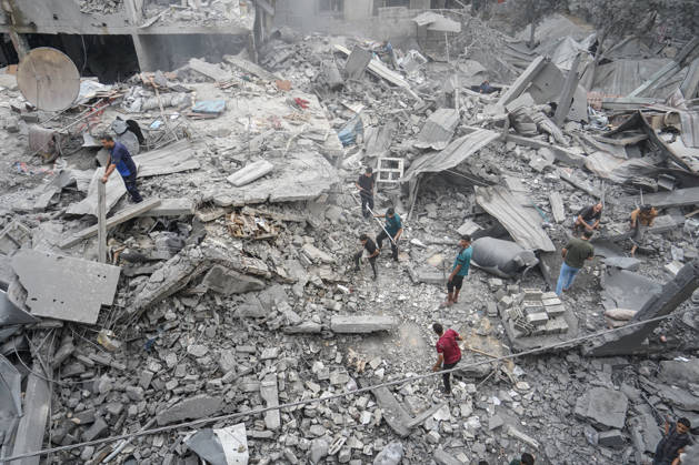 Israeli attack on Az-Zawayda area in Gaza DEIR AL-BALAH, GAZA, PALESTINE - OCTOBER 11: People search through the rubble of a building belonging to the Buheysi family following an Israeli airstrike in the town of Az-Zawayda, near Deir al-Balah in the central Gaza Strip, on October 11, 2026. Israeli forces carried out the strike despite the ceasefire, destroying the building and damaging surrounding structures. Adam Bilal Anadolu Deir Al-Balah Gaza. Editorial use only. Please get in touch for any other usage.  Copyright: x2026xAnadoluxAdamxBilalx