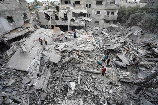 Israeli attack on Az-Zawayda area in Gaza DEIR AL-BALAH, GAZA, PALESTINE - OCTOBER 11: People search through the rubble of a building belonging to the Buheysi family following an Israeli airstrike in the town of Az-Zawayda, near Deir al-Balah in the central Gaza Strip, on October 11, 2026. Israeli forces carried out the strike despite the ceasefire, destroying the building and damaging surrounding structures. Adam Bilal Anadolu Deir Al-Balah Gaza. Editorial use only. Please get in touch for any other usage.  Copyright: x2026xAnadoluxAdamxBilalx