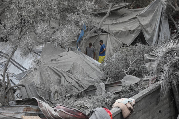 Israeli attack on Az-Zawayda area in Gaza DEIR AL-BALAH, GAZA, PALESTINE - OCTOBER 11: People stand near damaged tents and makeshift shelters following an Israeli airstrike targeting a building belonging to the Buheysi family in the town of Az-Zawayda, near Deir al-Balah in the central Gaza Strip, on October 11, 2026. Israeli forces carried out the strike despite the ceasefire, destroying the targeted building and damaging surrounding structures. Adam Bilal Anadolu Deir Al-Balah Gaza. Editorial use only. Please get in touch for any other usage.  Copyright: x2026xAnadoluxAdamxBilalx