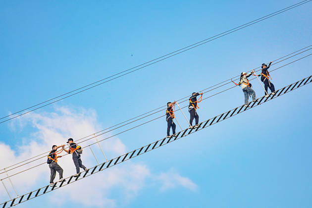 China Sky Ladder Challenger Tourists climb up a 250-meter-long soft ladder between two mountains in Mingtangshan Scenic Area in Yuexi county in central China s Anhui province, Sunday, Oct. 11, 2026. The rope ladder has 620 steps and a vertical distance of 365 meters. It opened to tourists in June this year, and quickly became a tourist attraction., Credit:stringer Utuku Feature China Avalon CHINA, ANHUI, YUEXI  Copyright: xstringerx xUtuku FeaturexChinax xAvalonx 1142342712