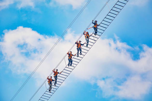 China Sky Ladder Challenger Tourists climb up a 250-meter-long soft ladder between two mountains in Mingtangshan Scenic Area in Yuexi county in central China s Anhui province, Sunday, Oct. 11, 2026. The rope ladder has 620 steps and a vertical distance of 365 meters. It opened to tourists in June this year, and quickly became a tourist attraction., Credit:stringer Utuku Feature China Avalon CHINA, ANHUI, YUEXI  Copyright: xstringerx xUtuku FeaturexChinax xAvalonx 1142342722