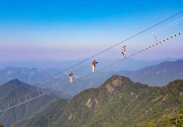 China Sky Ladder Challenger Tourists climb up a 250-meter-long soft ladder between two mountains in Mingtangshan Scenic Area in Yuexi county in central China s Anhui province, Sunday, Oct. 11, 2026. The rope ladder has 620 steps and a vertical distance of 365 meters. It opened to tourists in June this year, and quickly became a tourist attraction., Credit:stringer Utuku Feature China Avalon CHINA, ANHUI, YUEXI  Copyright: xstringerx xUtuku FeaturexChinax xAvalonx 1142342744