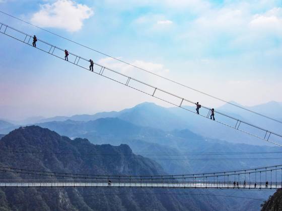 China Sky Ladder Challenger Tourists climb up a 250-meter-long soft ladder between two mountains in Mingtangshan Scenic Area in Yuexi county in central China s Anhui province, Sunday, Oct. 11, 2026. The rope ladder has 620 steps and a vertical distance of 365 meters. It opened to tourists in June this year, and quickly became a tourist attraction., Credit:stringer Utuku Feature China Avalon CHINA, ANHUI, YUEXI  Copyright: xstringerx xUtuku FeaturexChinax xAvalonx 1142342747