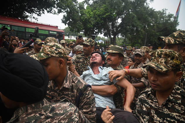 October 11, 2026, New Delhi, Delhi, India: Security personnel detain a protestor during a protest seeking the resignation of India s Chief Election Commissioner Gyanesh Kumar, over alleged electoral malpractices in the Special Intensive Revision (SIR) of electoral rolls, in New Delhi, India on October 11, 2026. New Delhi India - ZUMAj168 20261011_zip_j168_020 Copyright: xKabirxJhangianix