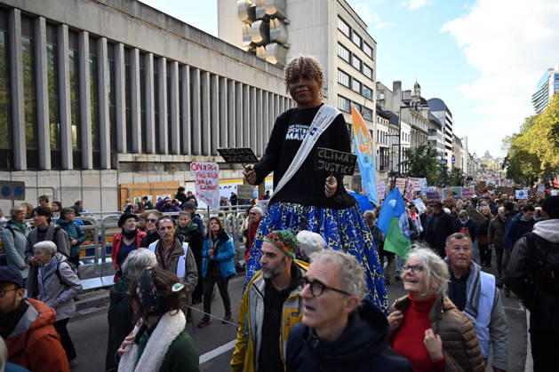 Tens of thousands march in Brussels demanding stronger climate action BRUSSELS, BELGIUM - OCTOBER 11: Demonstrators hold climate-themed placards as tens of thousands of people march through Brussels calling for stronger action against climate change and reduced dependence on fossil fuels, on October 11, 2026 in Brussels, Belgium. The protest was organized by the Belgian Climate Coalition, which brings together around 100 civil society organizations. Participants marched along major roads toward Schuman Square, home to several European Union institutions, while protesting the government s climate policies. Dursun Aydemir Anadolu Brussels Belgium. Editorial use only. Please get in touch for any other usage.  Copyright: x2026xAnadoluxDursunxAydemirx