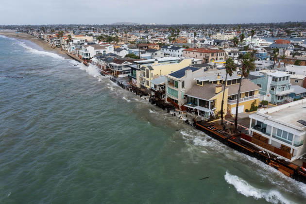 October 11, 2006, Long Beach, California, USA: The Long Beach Peninsula is facing severe, structural devastation as Tropical Storm Rachel batters the Southern California coast. Driven by a developing El Nino pattern, this is the fourth major storm system to slam the shoreline in six weeks. Waves and unusually high tides have shattered a 30-foot section of the protective wooden bulkhead, completely shredding the historic boardwalk and allowing seawater to surge directly onto interior streets. Flooding has swamped coastal neighborhoods, forcing mandatory evacuations along oceanfront blocks like Seaside Walk. Emergency crews are working to stack thousands of sandbags and reinforce coastal defenses, but city inspectors have already been forced - ZUMAr19_ 20261011_new_r19_125 Copyright: xRuaridhxStewartx
