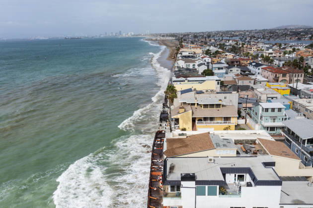 October 11, 2006, Long Beach, California, USA: The Long Beach Peninsula is facing severe, structural devastation as Tropical Storm Rachel batters the Southern California coast. Driven by a developing El Nino pattern, this is the fourth major storm system to slam the shoreline in six weeks. Waves and unusually high tides have shattered a 30-foot section of the protective wooden bulkhead, completely shredding the historic boardwalk and allowing seawater to surge directly onto interior streets. Flooding has swamped coastal neighborhoods, forcing mandatory evacuations along oceanfront blocks like Seaside Walk. Emergency crews are working to stack thousands of sandbags and reinforce coastal defenses, but city inspectors have already been forced - ZUMAr19_ 20261011_new_r19_128 Copyright: xRuaridhxStewartx