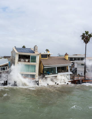 October 11, 2006, Long Beach, California, USA: The Long Beach Peninsula is facing severe, structural devastation as Tropical Storm Rachel batters the Southern California coast. Driven by a developing El Nino pattern, this is the fourth major storm system to slam the shoreline in six weeks. Waves and unusually high tides have shattered a 30-foot section of the protective wooden bulkhead, completely shredding the historic boardwalk and allowing seawater to surge directly onto interior streets. Flooding has swamped coastal neighborhoods, forcing mandatory evacuations along oceanfront blocks like Seaside Walk. Emergency crews are working to stack thousands of sandbags and reinforce coastal defenses, but city inspectors have already been forced - ZUMAr19_ 20261011_new_r19_148 Copyright: xRuaridhxStewartx