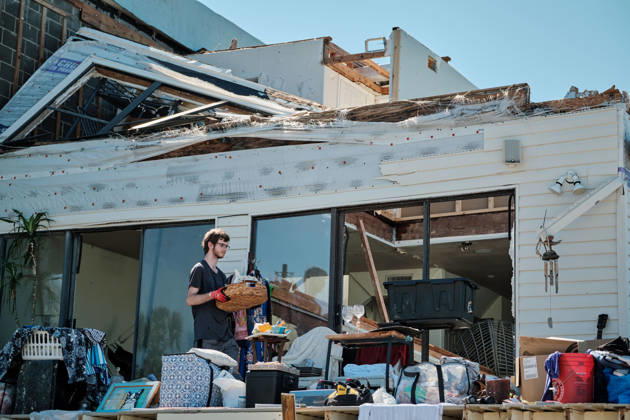 October 11, 2026, Pensacola Beach, Florida, U.S: October 11, 2026 Pensacola Beach, Florida USA: Alex Dean carries his belongs out of a storm damaged apartment complex after the arrival of Hurricane Isaias. Pensacola Beach U.S - ZUMAa14_ 20261011_zaf_a14_003 Copyright: xDanxAndersonx