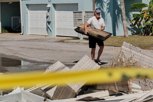 October 11, 2026, Pensacola Beach, Florida, U.S: October 11, 2026 Pensacola Beach, Florida USA: A resident of a storm damaged apartment complex unloads his shovel on a pile of trash while cleaning out his apartment after the arrival of Hurricane Isaias. Pensacola Beach U.S - ZUMAa14_ 20261011_zaf_a14_015 Copyright: xDanxAndersonx