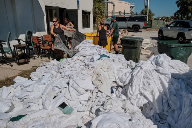 October 11, 2026, Pensacola Beach, Florida, U.S: October 11, 2026 Pensacola Beach, Florida USA: People clear out bed sheets and towels from the storm damaged building for Paradise Beach and Homes after the arrival of Hurricane Isaias. Pensacola Beach U.S - ZUMAa14_ 20261011_zaf_a14_026 Copyright: xDanxAndersonx