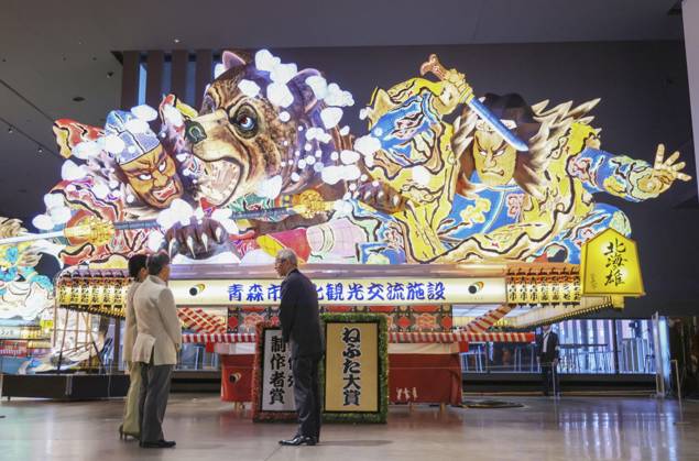 Emperor views Nebuta Festival float Japan s Emperor Naruhito (L) and Empress Masako look at a decorated float that was used at the Aomori Nebuta Festival in August, during a visit to a sightseeing facility in the northeastern Japan city on Oct. 11, 2026. (Pool photo)  A14AA0005630644P