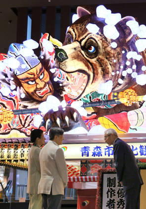 Emperor views Nebuta Festival float Japan s Emperor Naruhito (C) and Empress Masako look at a decorated float that was used at the Aomori Nebuta Festival in August, during a visit to a sightseeing facility in the northeastern Japan city on Oct. 11, 2026. (Pool photo)  A14AA0005630643P