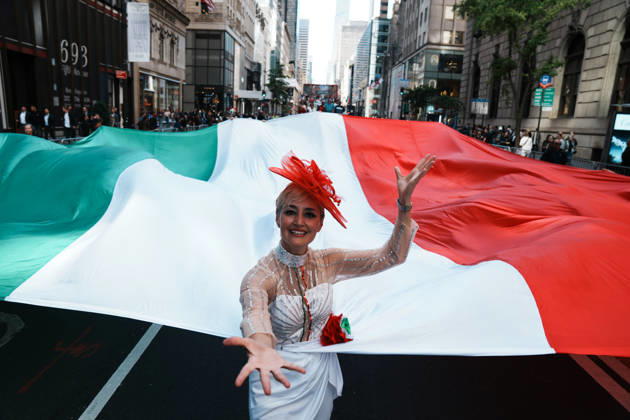 October 12, 2026, New York, New York, USA: A woman holds an Italian flag at the 82nd Annual Columbus Day Parade up Fifth Avenue on October 12, 2026 in New York. This year s celebration commemorates 250 Years of Italian Contribution to America, honoring the generations who helped shape the nation and the vibrant community that continues to carry their legacy forward. New York USA - ZUMAb148 20261012_zap_b148_034 Copyright: xBryanxSmithx