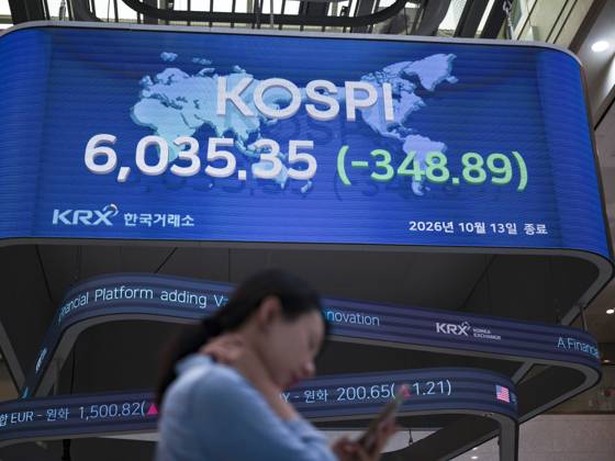 South Korea Stocks Plunge As KOSPI Drops Sharply At KRX In Seoul A Korea Exchange (KRX) employee checks her mobile phone in front of the main display showing the closing KOSPI index at 6,035.35 (-348.89) in Yeouido, Seoul, South Korea, on October 13, 2026. Seoul Seoul South Korea  Copyright: xChrisxJungx originalFilename: jung-southkor261013_npbPk.jpg
