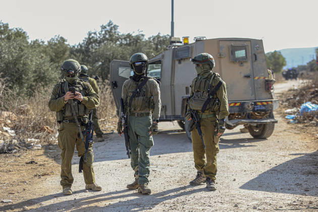 Settlers Disrupt Turmus Ayya Harvest Three armed Israeli soldiers stand beside an armored vehicle on a dirt road lined with olive trees in Turmus Ayya, near Ramallah, in the Israeli-occupied West Bank, on October 13, 2026. Palestinian news agency WAFA, citing local sources, reported that Israeli settlers attacked the town and tried to prevent residents from reaching their land to harvest olives. Ramallah West Bank Palestinian Territories Copyright: xMohammadxNazalx
