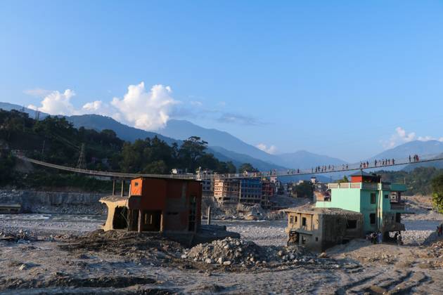 Nepal Bridge Restores Flood-Hit Access NUWAKOT, NEPAL, OCTOBER 14, 2026: Residents cross a newly built suspension bridge over the Trishuli River in Nuwakot, restoring access between communities affected by flash floods. Flooding destroyed bridges and damaged roads in the district, disrupting travel and access to essential services. NUWAKOT Nepal Copyright: x xShankarxBhujelx xJNAxPressx
