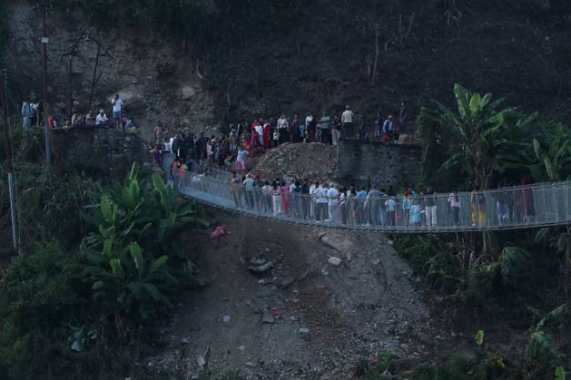 October 14, 2026, Nuwakot, Nepal: NUWAKOT, NEPAL, OCTOBER 14, 2026: Residents cross a newly built suspension bridge over the Trishuli River in Nuwakot, restoring access between communities affected by flash floods. Flooding destroyed bridges and damaged roads in the district, disrupting travel and access to essential services. Nuwakot Nepal - ZUMAq101 20261014_zna_q101_128 Copyright: xShankarxBhujelx