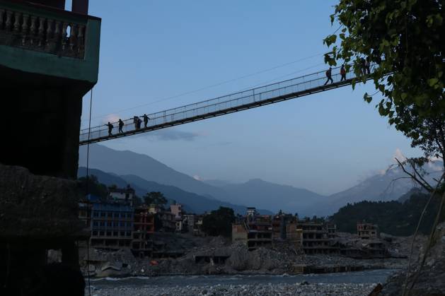 October 14, 2026, Nuwakot, Nepal: NUWAKOT, NEPAL, OCTOBER 14, 2026: Residents cross a newly built suspension bridge over the Trishuli River in Nuwakot, restoring access between communities affected by flash floods. Flooding destroyed bridges and damaged roads in the district, disrupting travel and access to essential services. Nuwakot Nepal - ZUMAq101 20261014_zna_q101_129 Copyright: xShankarxBhujelx