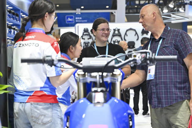 GUANGZHOU, CHINA - OCTOBER 15: Overseas buyers look at motorcycles displayed by Chinese motorcycle brand Zhangxue Motorcycle (ZXMOTO) during the 140th China Import and Export Fair (Canton Fair) on October 15, 2026 in Guangzhou, Guangdong Province of China. The fair runs in three phases until November 4, covering a total exhibition area of 1.55 million square meters.  Copyright: xChinaxNewsxServicex 111674432301
