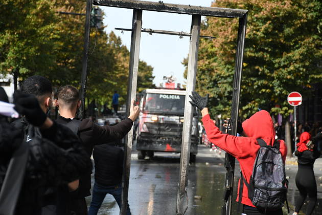 Student protests demanding improved educational conditions continue in Albania TIRANA, ALBANIA - OCTOBER 15: Protesters hold up a large metal frame as a police water cannon vehicle approaches during the third day of demonstrations demanding improved educational conditions in Tirana, Albania, on October 15, 2026. University students are joined by high school students and local residents as tensions escalate, with police using tear gas to disperse demonstrators outside the Ministry of Education and the Parliament building, while protesters throw stones and other objects at police officers. Olsi Shehu Anadolu Tirana Albania. Editorial use only. Please get in touch for any other usage.  Copyright: x2026xAnadoluxOlsixShehux