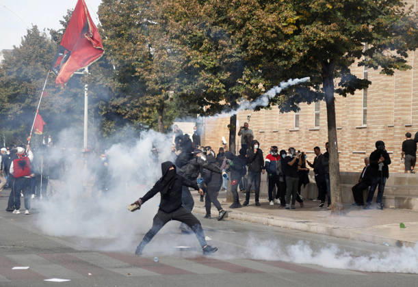 Protesters Clash with Police During a Demonstration in Tirana, Albania. Protesters hold an Albanian flag as they throw stones to riot police during an anti-government demonstration in central Tirana on October 15, 2026, as protests continued for a third consecutive day over university conditions and demands for the resignation of Albanian Prime Minister Edi Rama. The latest rally follows two nights of violence in the capital, during which protesters and riot police clashed, police used water cannons and tear gas, and demonstrators damaged government offices and shops and set fire to several buildings. Light Studio Agency Malton Dibra Tirana Albania Copyright: xLightxStudioxAgencyx xMaltonxDibrax